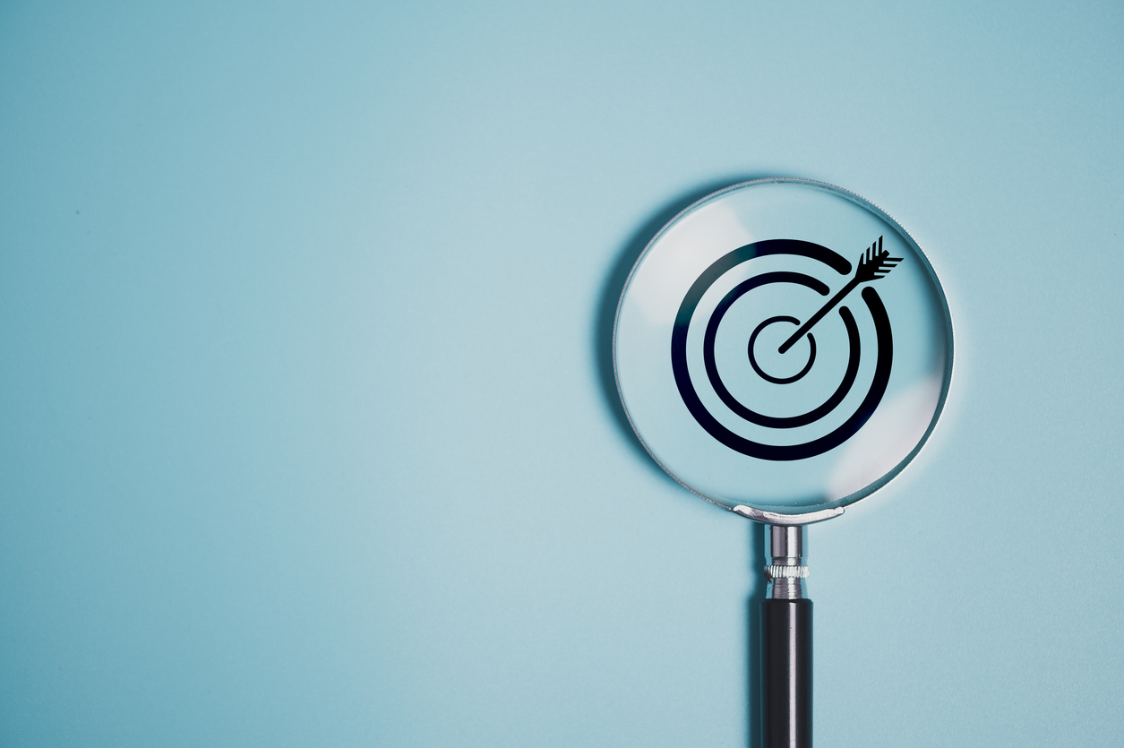 Magnifying glass focused on a target, representing MarraTech's mission