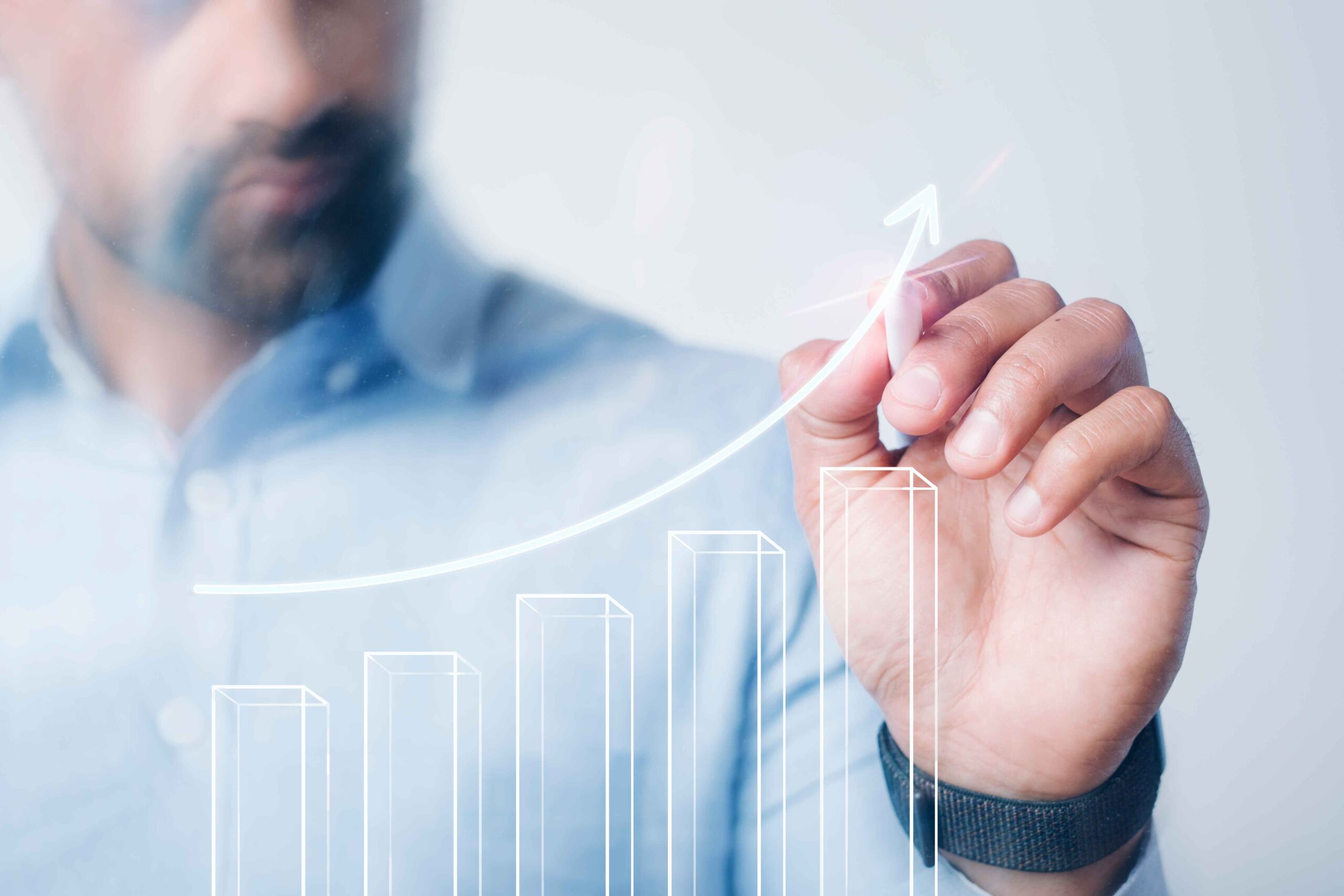 Businessperson drawing a rising growth chart