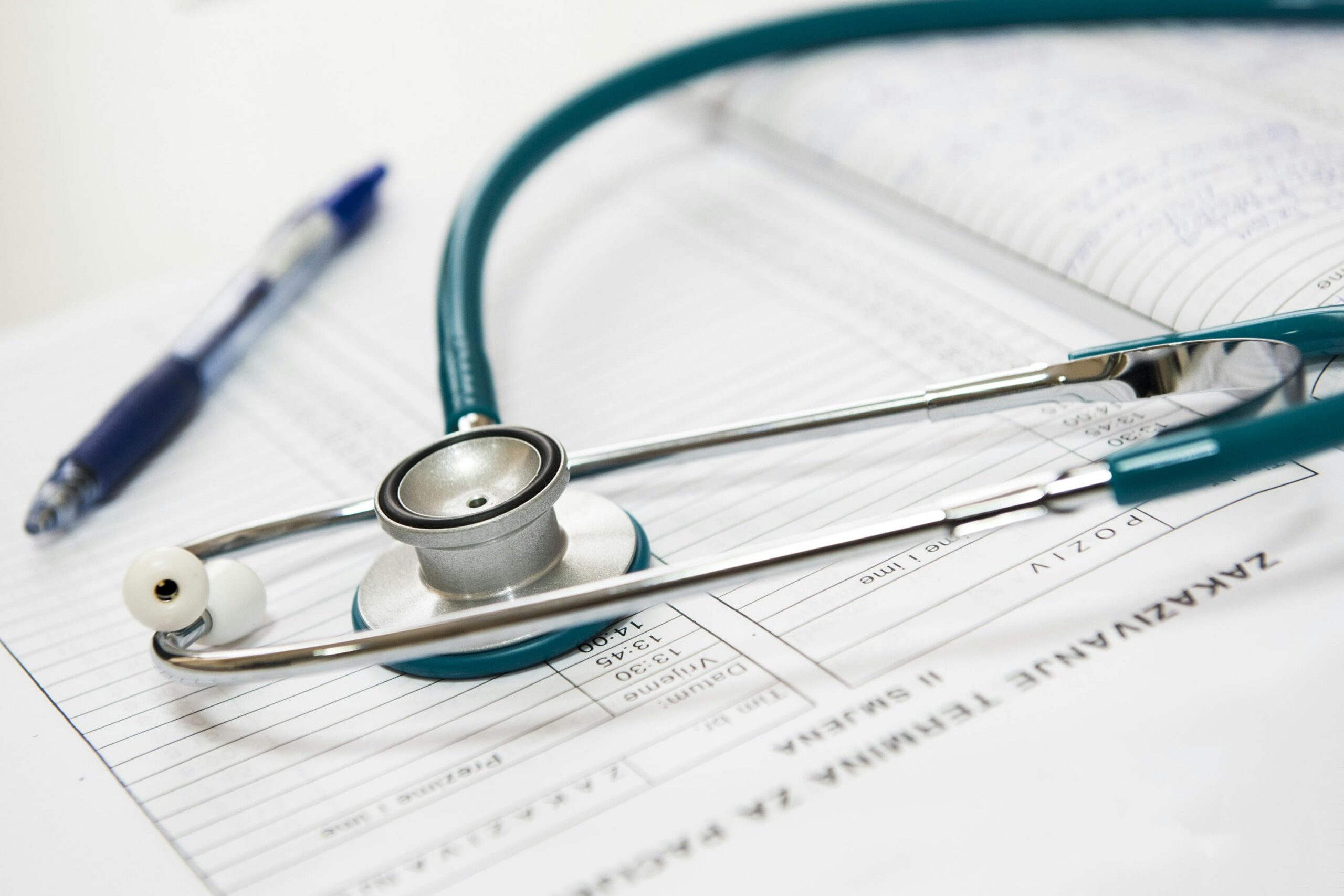 Stethoscope and pen on medical documents