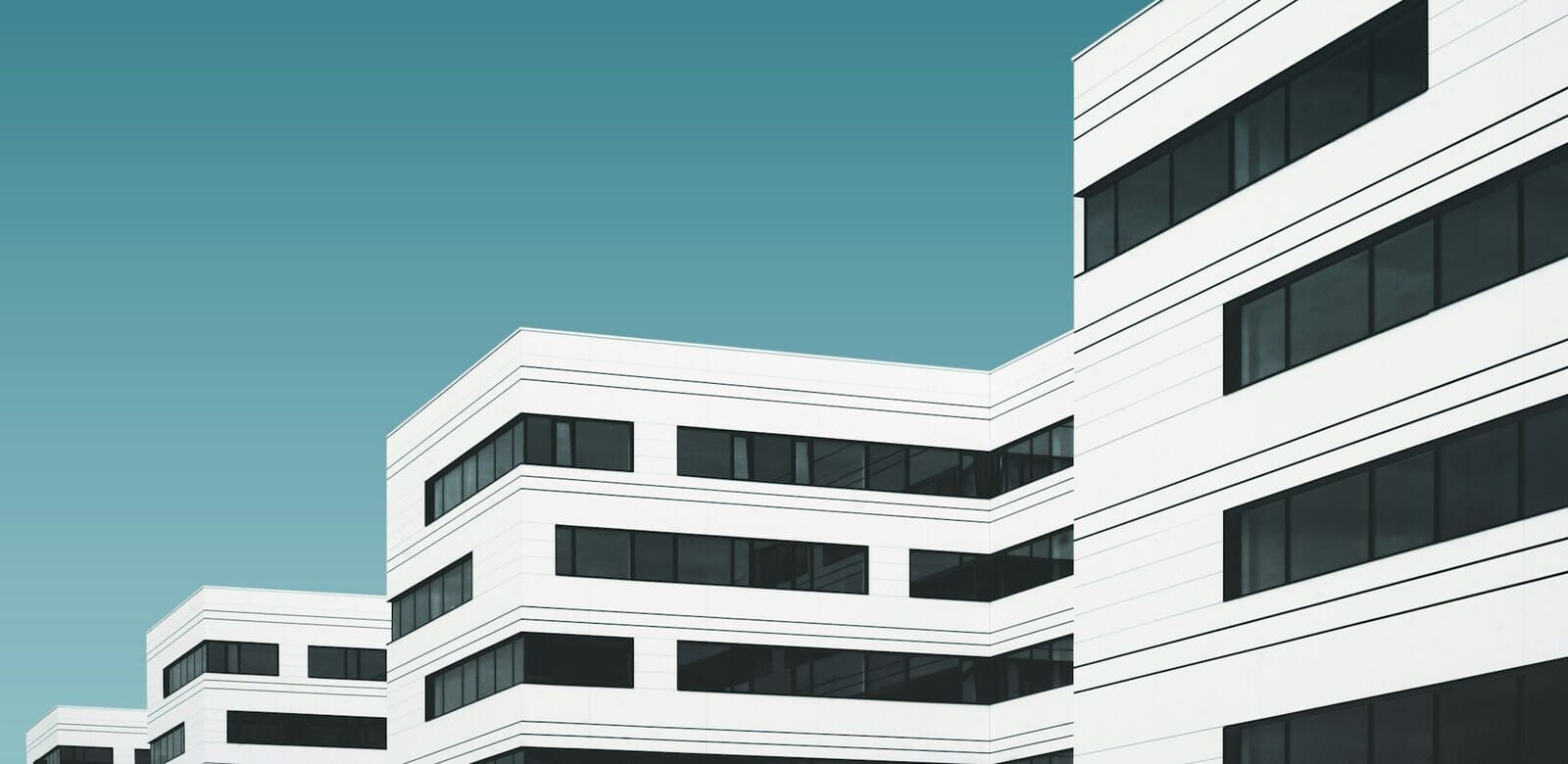 Modern white hospital building against a blue sky