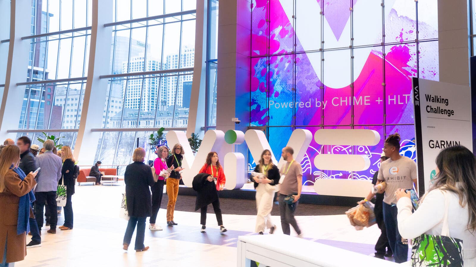 Attendees in the ViVE conference exhibition hall